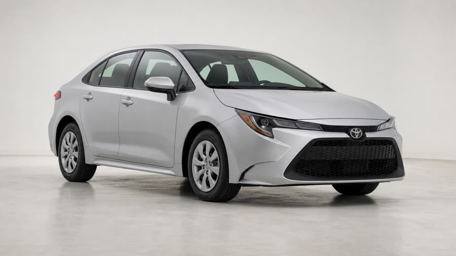 A silver compact sedan in a bright, high-key studio